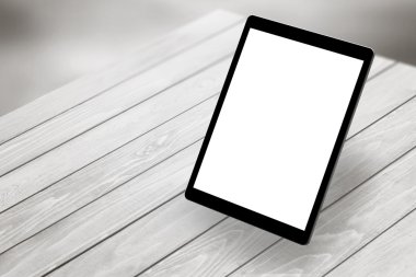 Tablet with white isolated screen on wooden desk. Isometric view 