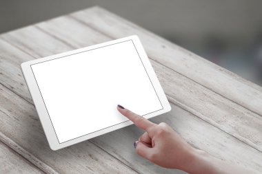 Woman hand touch tablet screen on wooden desk. Isometric view 