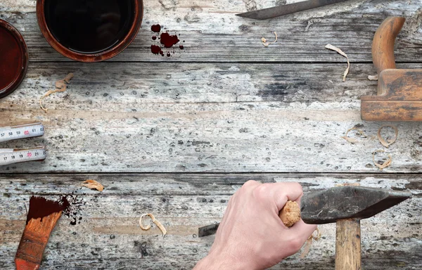 Woodworking tools with free space for text. Hammer and chisel in hand, beside is brush, paint, wood plane, ruler, shavings.