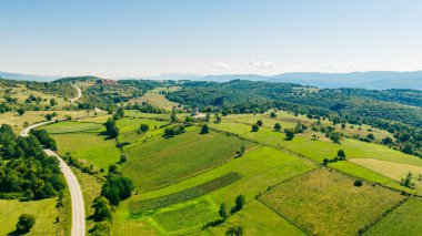 Countryside Orthodox church on hill among fields and trees in Bosnia