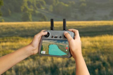 Drone denetleyicisi haritalanmış arazi alanını ölçüm örtüsüyle gösteriyor, tarımsal gözlem, haritalama ve hassas insansız hava aracı görevleri için kullanılıyor.