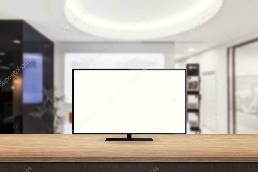 isolated tv on wooden desk in office background for mock up presentation