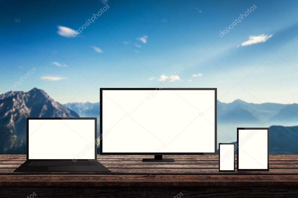 isolated responsive computer and mobile devices on desk with mountain nature background for mock up presentation