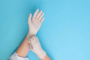 Koruyucu lateks eldiven giyen doktor tıbbi prosedüre, hijyen, enfeksiyon önleme ve sağlık güvenliğine elele hazırlanıyor.