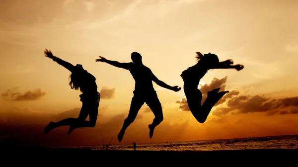 Trois silhouettes au coucher du soleil Images De Stock Libres De Droits