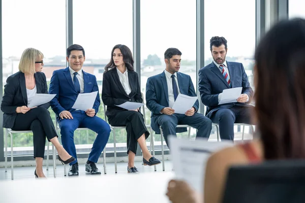 Group of people sitting and waiting for job interview.