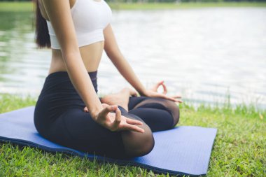 Bahçede yoga yapan genç bir kadın