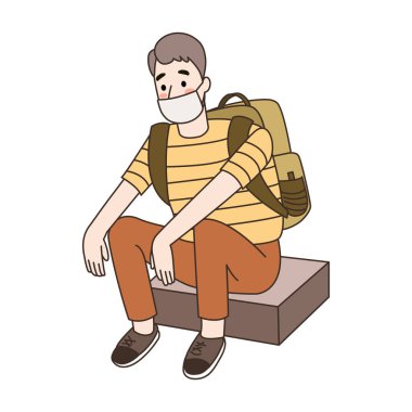 Genç adam otururken maske takıyor..