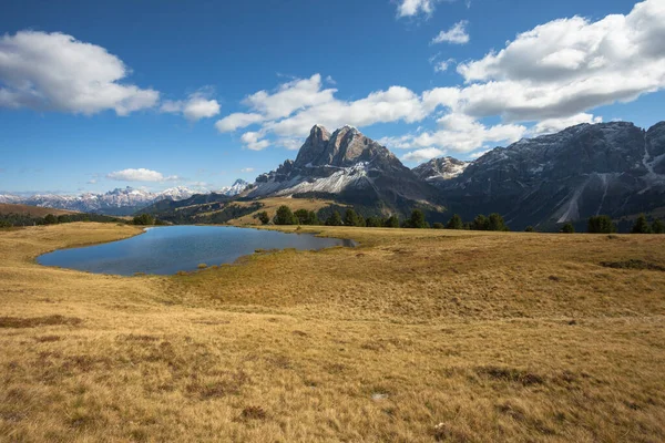 Sass de Putia, akşamları Dolomitler 'deki küçük bir alp gölüne yansıyor.