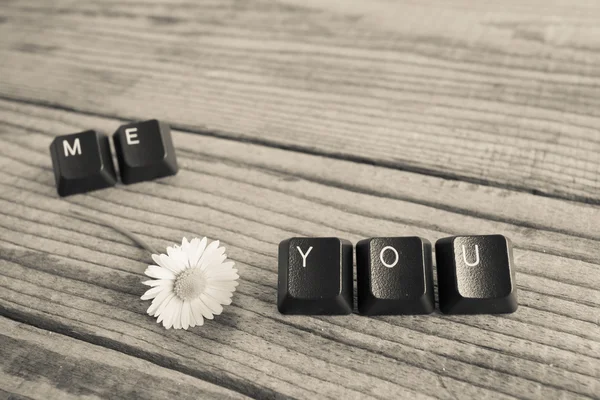 "you and me "wrote with keyboard keys on wooden background, blac — стоковое фото