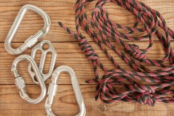 Mountain gear for climbing on wooden background — Stock Photo, Image