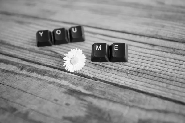 "you and me "wrote with keyboard keys on wooden background, blac — стоковое фото