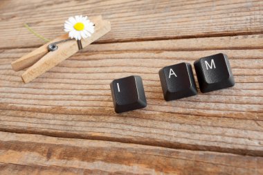 I AM wrote with keyboard keys on wooden background clipart