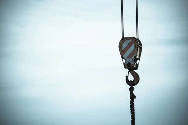 Focus on crane at work, blue tone — Stock Photo, Image