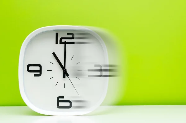 White modern clock on light blue background — Stock Photo, Image
