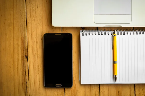 空白的笔记本和手机与笔记本电脑上的黄色笔 — 图库照片