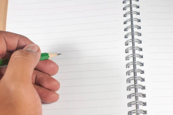 En hand skriver om tom sida notebook — Stockfoto
