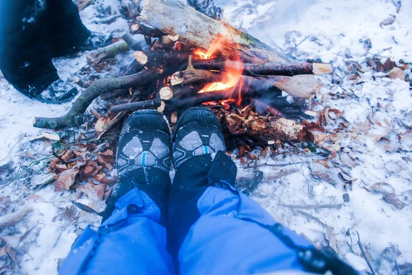 Détente au coin du feu de camp en hiver - femme en bottes de randonnée — Photo