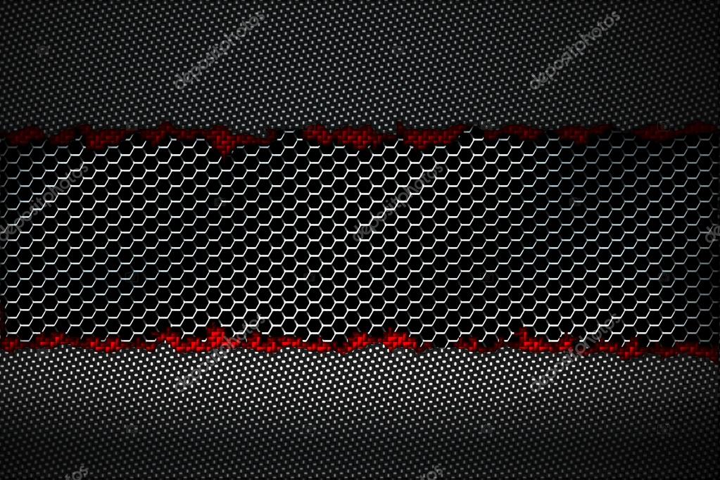 Black and red carbon fiber tear on the metallic mesh. Stock Photo by ©koo 119282382