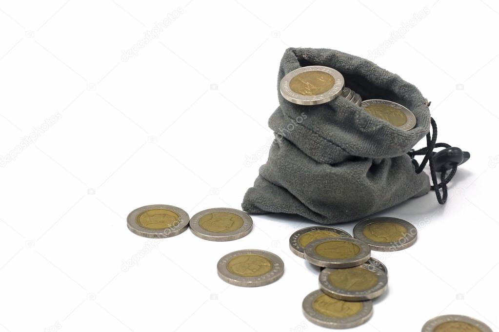 Coins in a cloth bag isolated background.
