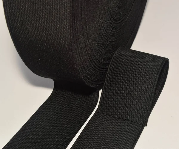 Black elastic spool, the elastic band is made of polyester fibres.