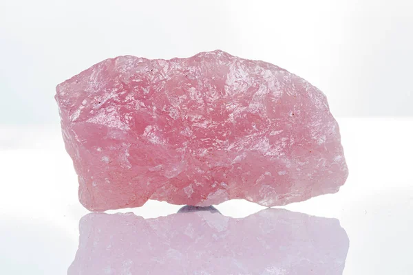 macro mineral stone rose quartz on a white background close-up