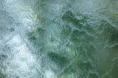 Camın sonsuz yüzeyinde akan su deseni.