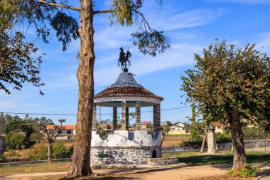 Etrafı ağaçlarla çevrili küçük parktaki binicilik heykeli olan dairesel pavyon, Portekiz, Ovar Furadouro, 14 Ekim 2025