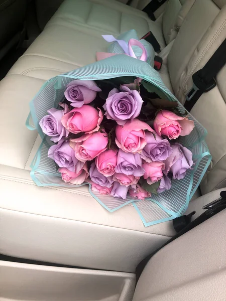 Egy csokor rózsa az autó hátsó ülésén — Stock Fotó