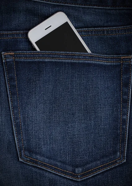 mobile phone seen from the back pocket of jeans, blue denim.