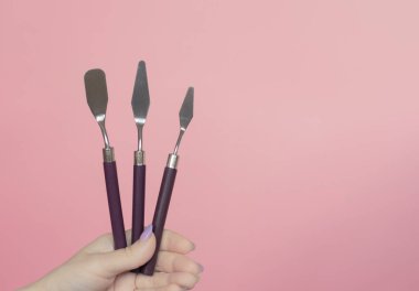 Cake Cream Spatula. pink background. Stainless Steel Frosting Baking Pastry. Decorating Tool Set. Baking tools frosting cream smoothing. Professional pastry utensils confectionery dessert preparation