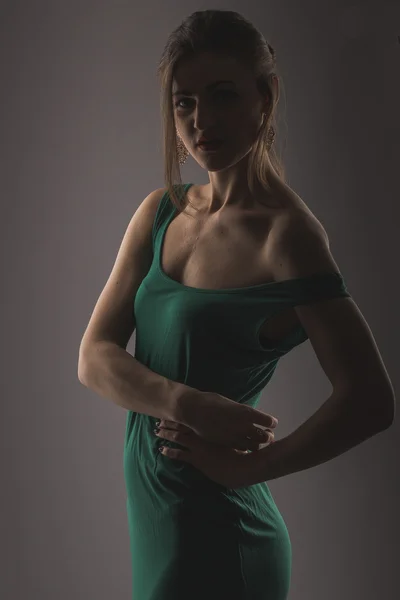 Portrait of young beautiful woman in green dress — Stock Photo, Image