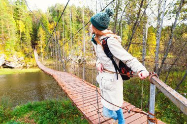 Genç kız eski tahta köprüde ayakta