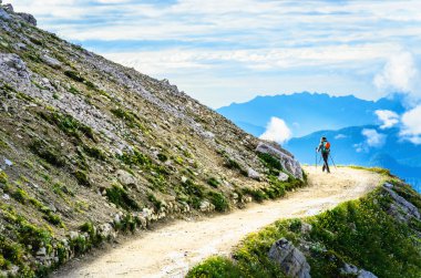 Tourist with a backpack trekking  in the  mountains