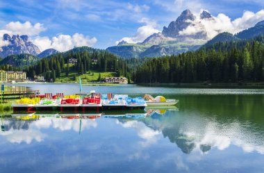 peaceful lake with pedal boats clipart