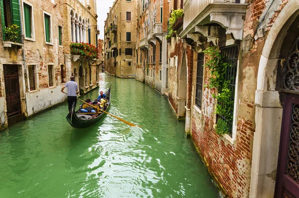 Narrow canal with gondola — Stock Photo, Image