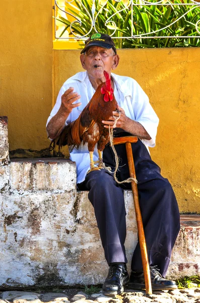 Old man with rooster — Stock Photo, Image