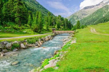 Mountain stream and high peaks of Austrian Alps clipart