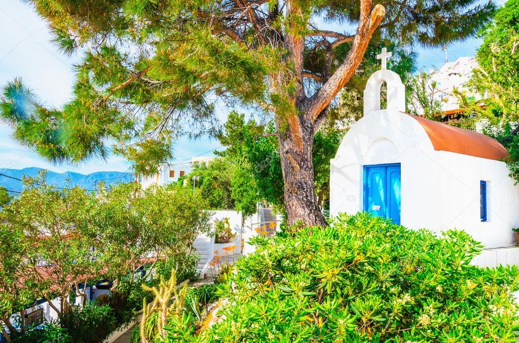 Small white Greek church with blue doors, Greece