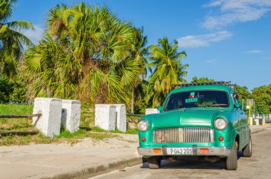 Green classic American car on street of Havana clipart