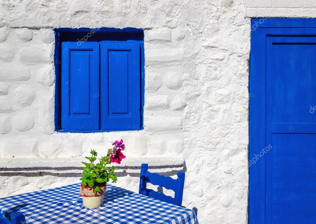 blue table with wooden chairs , Greece
