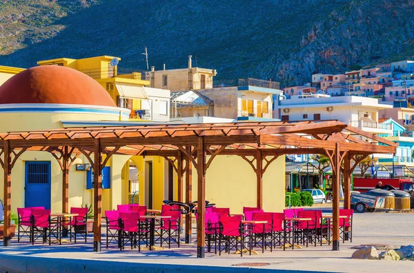 Colorful restaurant with red chairs, Greece — Stock Photo, Image