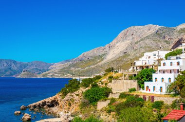 Typical Greek houses on coast of Aegean Sea Greece clipart