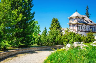 White hotel on a mountain lake Strbske Pleso  clipart