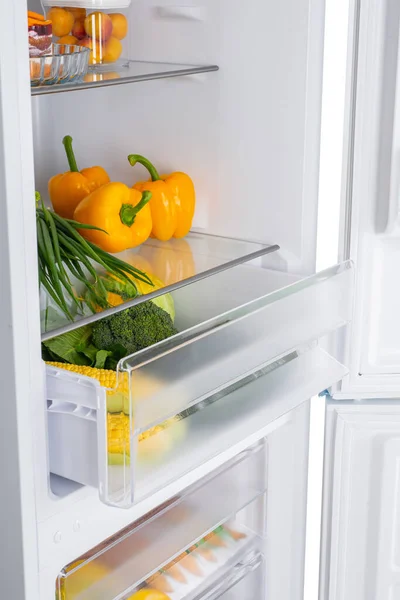 Open fridge full of fresh fruits and vegetables, healthy food background, organic nutrition, health care, dieting concept