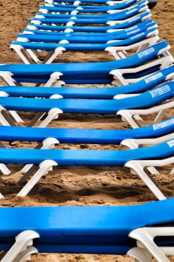 Benidorm, Alicante, Spain- September 9, 2019: Lonely Blue hammocks lined up on Levante Beach in Benidorm, Alicante