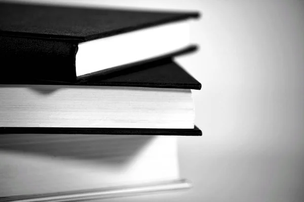 Black and white books stacked on white background