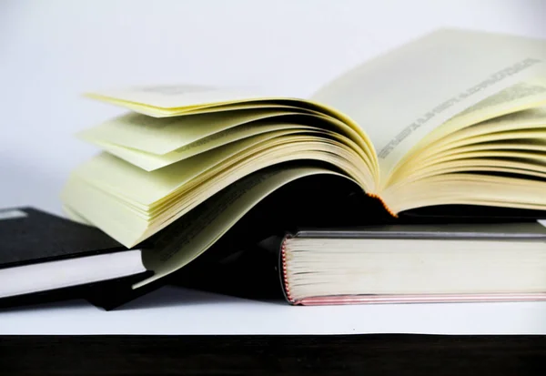 Black and white books stacked on white background