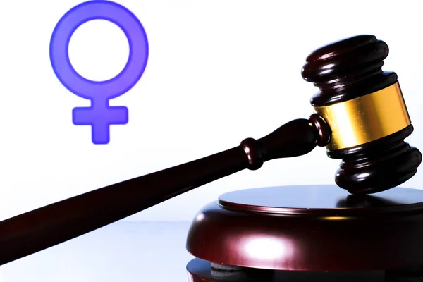 Judge wooden mallet and gender symbol on white background