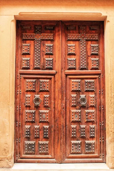 Old colorful carved wooden door in a small village in Castilla La Mancha community, Spain